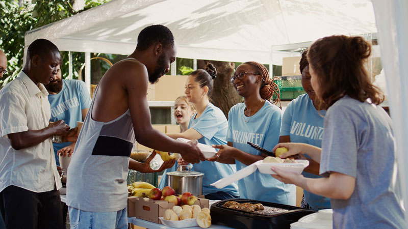 Multiethnic voluntary individuals distribute donated food