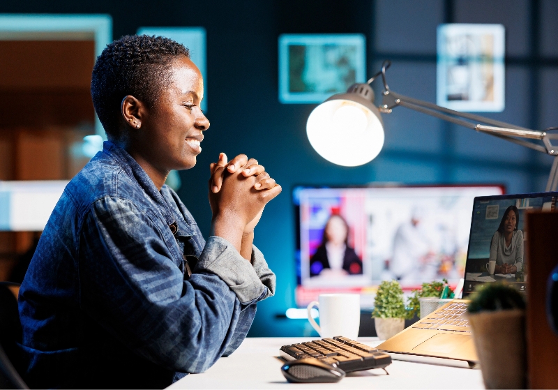 Smiling African American woman engages in virtual communication